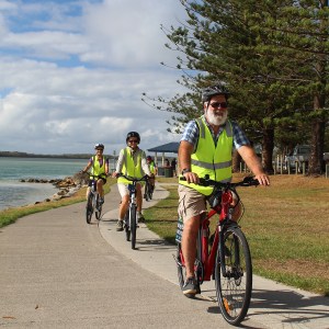 a group of people riding on the back of a bicycle