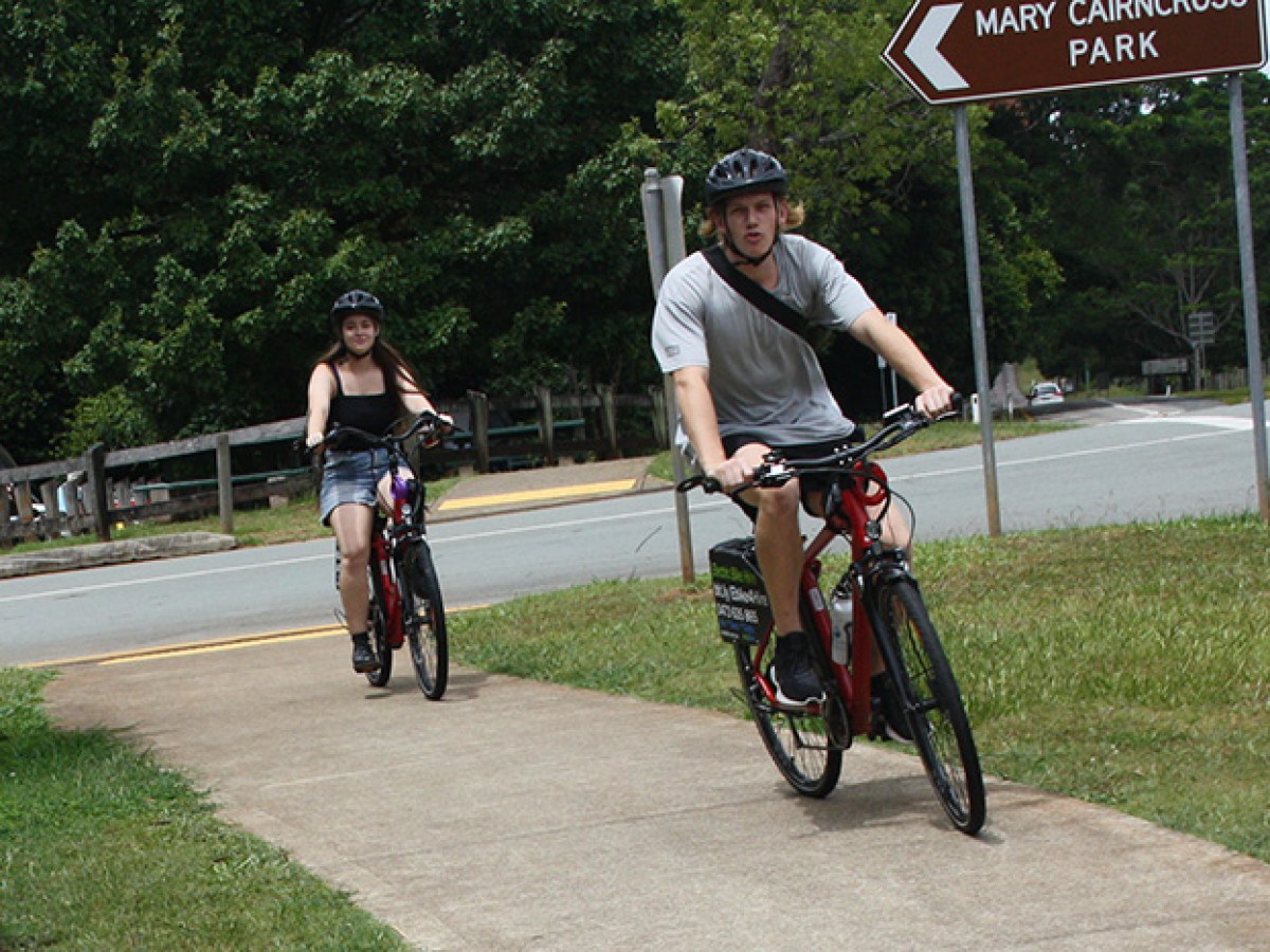 Couple on e-bikes enjoying a ride along Mt View Road after a visit to Mary Cairncross Scenic Reserve, Maleny.