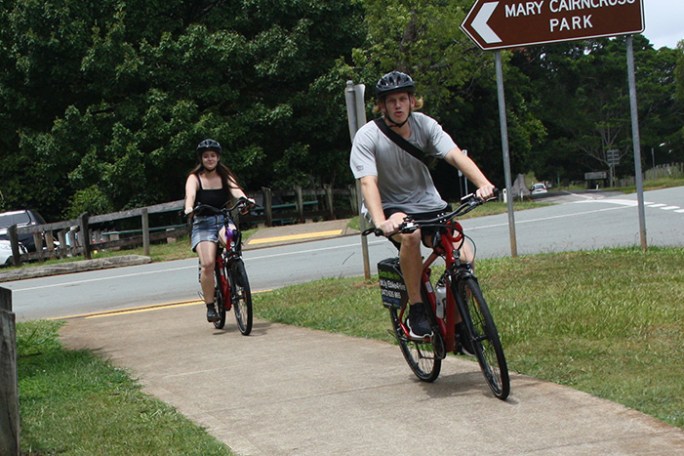Couple on e-bikes enjoying a ride along Mt View Road after a visit to Mary Cairncross Scenic Reserve, Maleny.