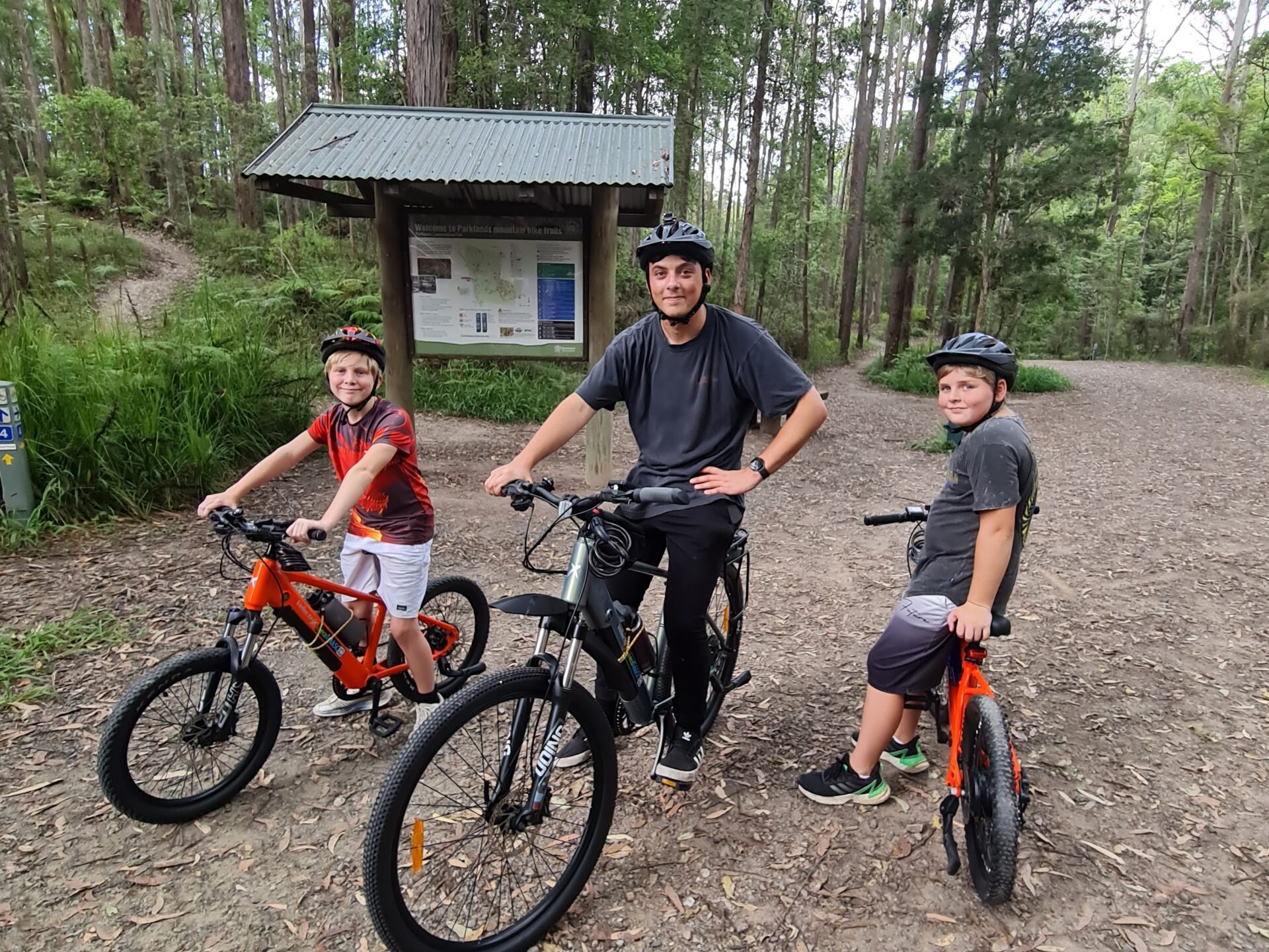 Three brothers poised for an e-MTB adventure at Parklands MTB park on ecoTekkSC electric bikes.