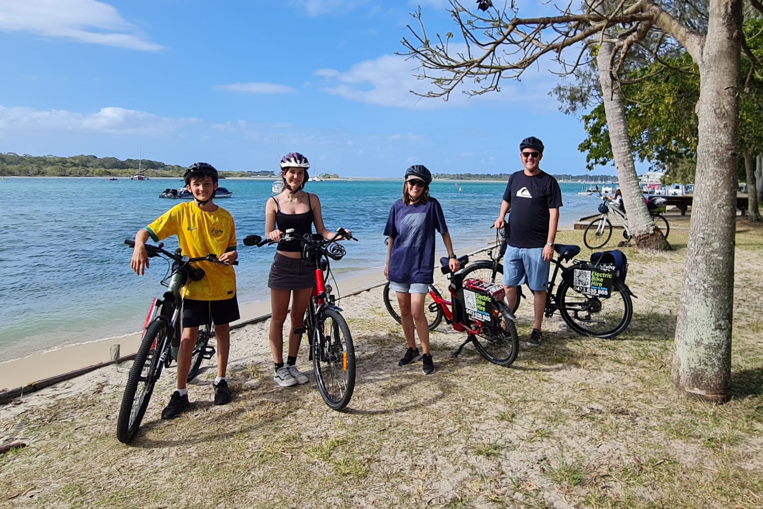 Family of four riding e-Bikes on a scenic tour in Noosa, provided by ecoTekk Noosa, showcasing beautiful landscapes and family-friendly adventure.