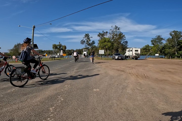 a person riding a bicycle on the side of a road