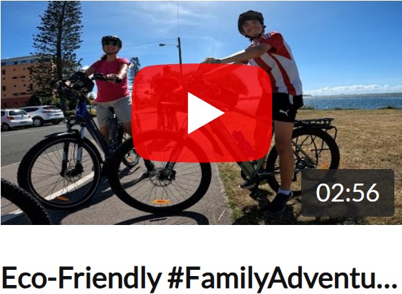 Mum on a city e-bike and Son on an e-MTB riding along the scenic coastal pathway at Golden Beach, Caloundra, featured in a video blog.